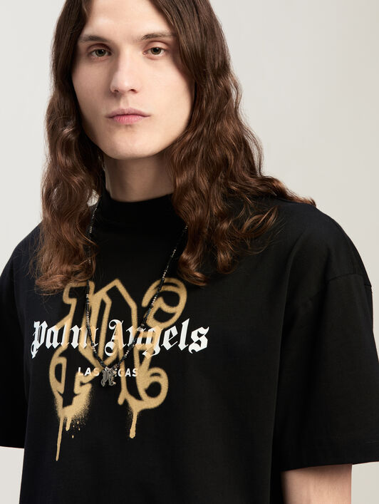 Las Vegas Monogram Spray Tee PALM ANGELS Las Vegas Monogram Spray Tee BLACK GOLD PMAA001C99JER031