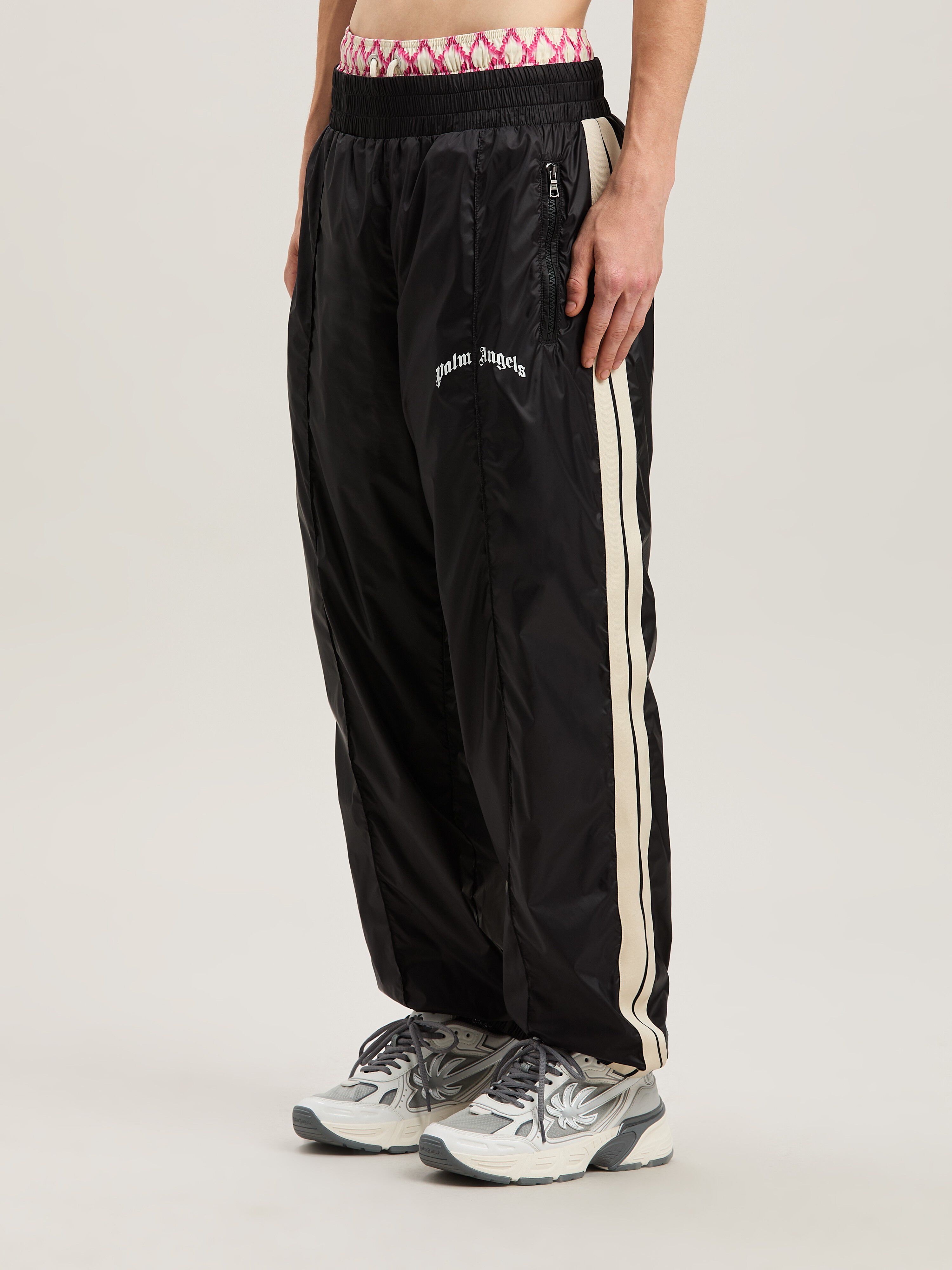 PALM ANGELS  Nylon Track Pants Curved Logo BLACK - GREY PMCA179S25FAB001