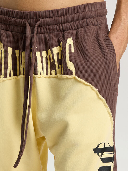 Vintage Logo Loose Sweatpants PALM ANGELS Vintage Logo Loose Sweatpants BROWN - LIGHT YELLOW PAMCH03F26FL01