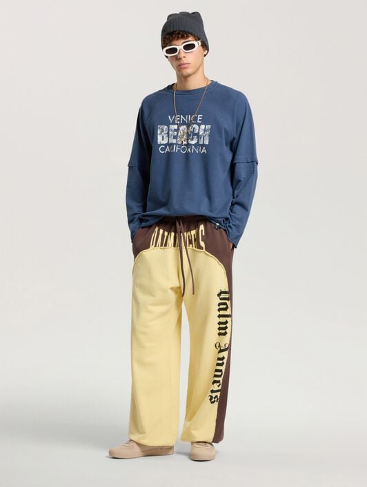 Vintage Logo Loose Sweatpants PALM ANGELS Vintage Logo Loose Sweatpants BROWN - LIGHT YELLOW PAMCH03F26FL01